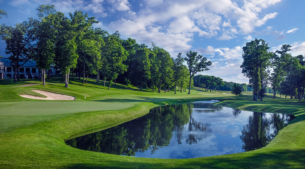 The 18th at TPC Deere Run, a downhill par 4 to a green guarded by water